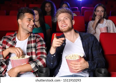 Friends With Popcorn Watching Movie In Cinema