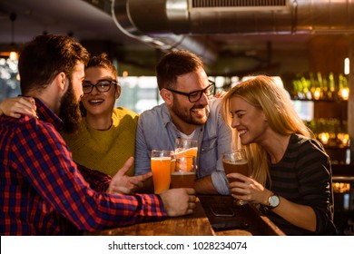 Friends in the Pub. Drinking beer, talking, having fun.