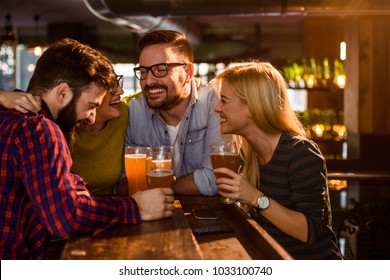 Friends in the Pub. Drinking beer, talking, having fun. - Powered by Shutterstock