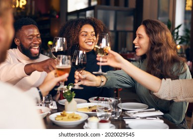 Friends Raising Glasses In Restaurant