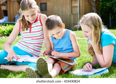 Friends reading book outdoors on grass in summer day - Shutterstock ID 433430824
