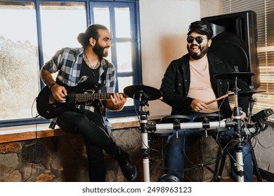 Friends rehearsing at home, guitar and drums. Music band. International music day. - Powered by Shutterstock