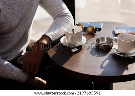 Friends in a restaurant talking smiling and drinking tea. Business colleagues having a meeting after work at a cafe bar. Abstract photo.