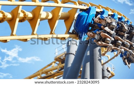Friends riding amusement park ride