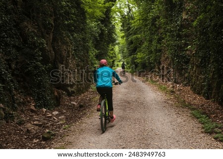 Similar – Radfahrer auf Waldweg