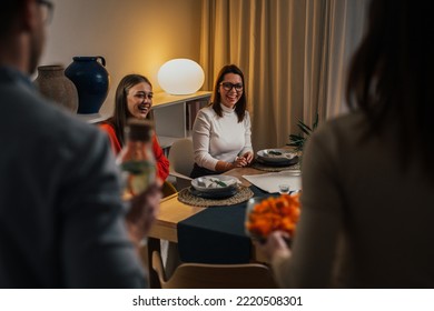 Friends Serving Food At The Home Dinner Party