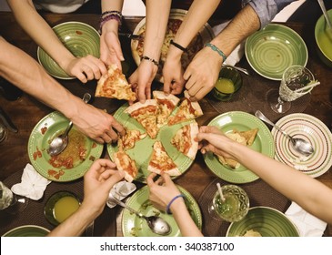Friends Sharing Pizza At Home.