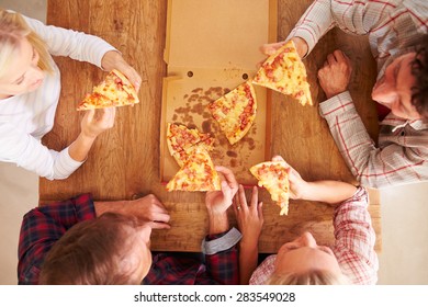 Friends Sharing A Pizza Together, Overhead View