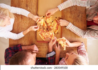 Friends Sharing A Pizza Together, Overhead View