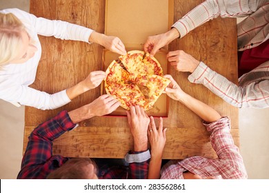 Friends Sharing A Pizza Together, Overhead View