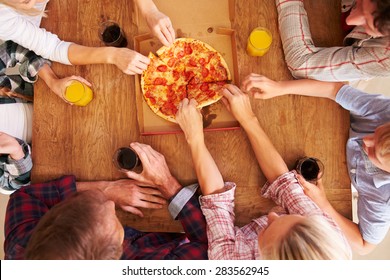 Friends Sharing A Pizza Together, Overhead View