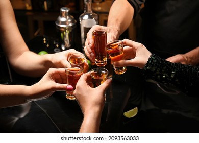Friends with shots of tasty tequila in bar - Powered by Shutterstock