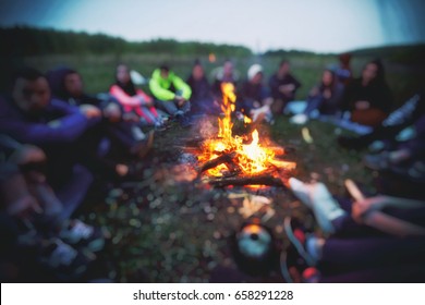 Friends are sitting around the bonfire