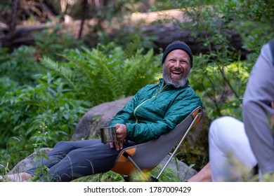 Friends Sitting By A Creek Enjoying Some Breakfast Coffee In Kings Canyon National Park. 