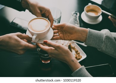 Friends sitting in cafe and drinking coffee. Toned image - Shutterstock ID 1030119520