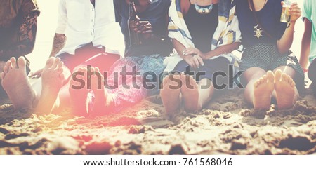 Friends sitting in the sand on a beach