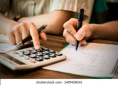 friends sitting use calculator,Calculate studying examining, Tutor books with Young students campus helps catching up and learning. People  education