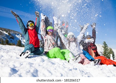 Friends With Snowboards Throwing Snow