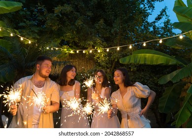 Friends with sparklers celebrate. Fireworks with bengal fireworks. Festive magic. Happy birthday, new year concept