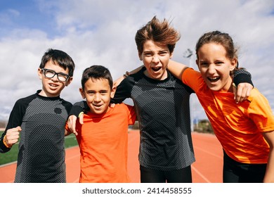 Friends in a sports team standing on running track- with arms around- shouting - Powered by Shutterstock