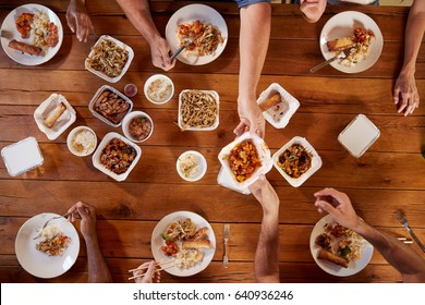 Friends at a table sharing Chinese take-away, overhead view