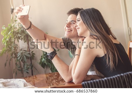 Friends taking a selfie, a woman and a man, young people