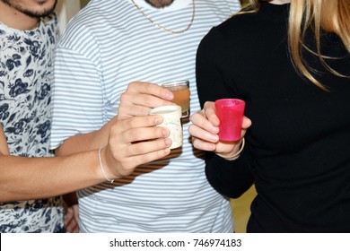 Friends Taking Shots Of Alcohol Together At A Nightclub
