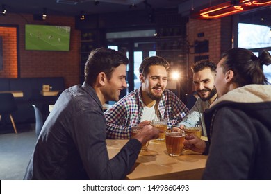 Friends Talk, Drink Beer In A Bar.