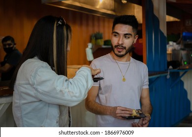 Friends Talking And Eating Tacos De Pastor. Mexican Food Concept