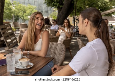 Friends Talking At The Outside Cafe Bar