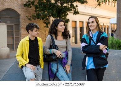 Friends talking while standing outdoors on the street. - Powered by Shutterstock