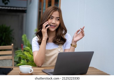 Friends Teenager Buddies Concept. Asian Teen Talking With Friends By Smart Phone At Cafe