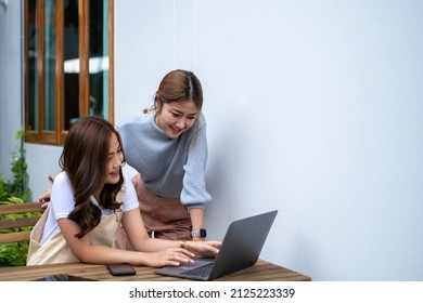 Friends Teenager Buddies Concept. Asian Teen Talking And Looking At Content In Laptop Computer.