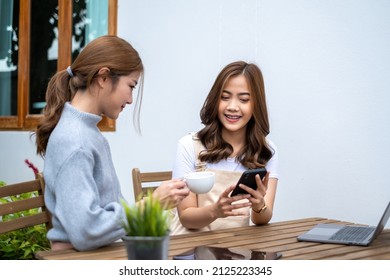 Friends Teenager Buddies Concept. Asian Teen Talking And Looking At Content In Smart Phone.