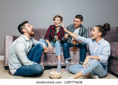 Friends Are Throwing Popcorn Into The Man's Mouth. Full Length Photo. Friendship