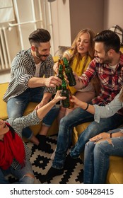 Friends Toasting With Beer On A Home Party.