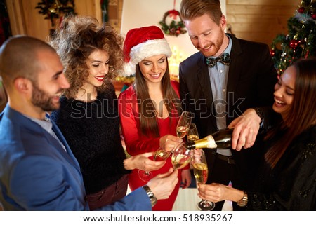 Friends toasting with Champaign at midnight for New Year 