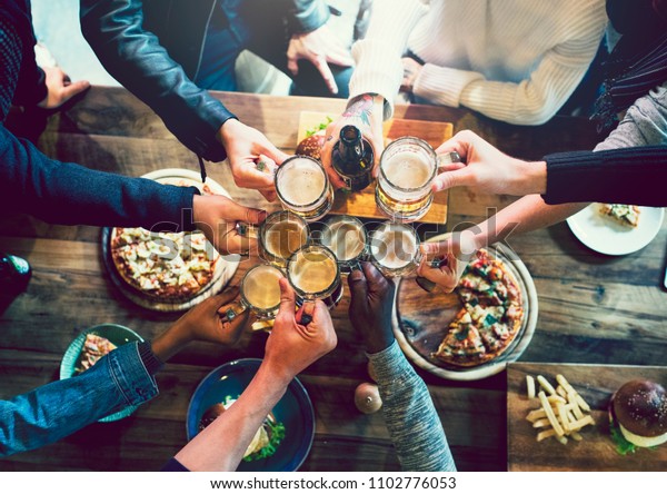 Friends toasting with craft\
beer