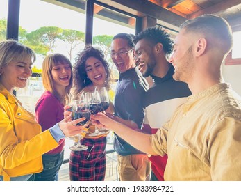 Friends toasting and drinking red wine at restaurant - Food lifestyle concept with happy people having fun together - Concept about with happy people having fun together at winery bar - Powered by Shutterstock