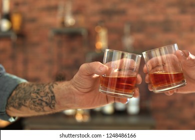 Friends Toasting With Glasses Of Whiskey Indoors, Closeup