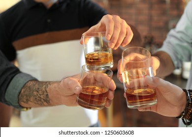 Friends Toasting With Glasses Of Whiskey Indoors, Closeup