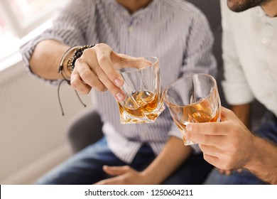 Friends Toasting With Glasses Of Whiskey Indoors, Closeup