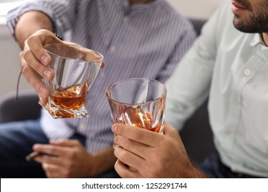 Friends Toasting With Glasses Of Whiskey Indoors, Closeup