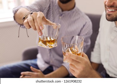 Friends Toasting With Glasses Of Whiskey Indoors, Closeup