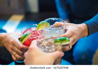 Friends Toasting With Margaritas And Tropical Drinks.  Cheers!