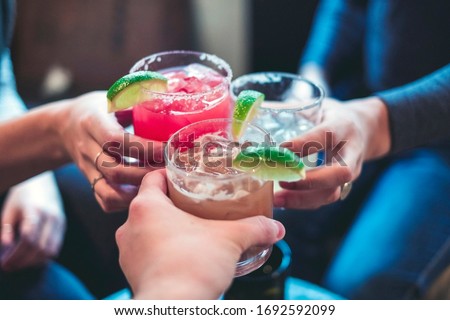 Friends toasting with margaritas and tropical drinks.  Cheers! Stockfoto © 
