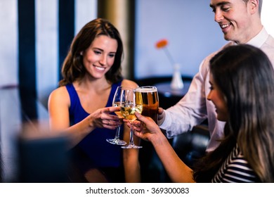 Friends toasting together in a bar
