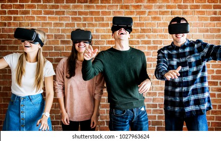 Friends trying on VR headsets - Powered by Shutterstock