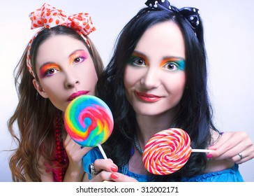 Friends. Two girls with creative visage and in bright cloth