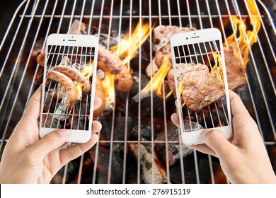 friends using smartphones to take photos of sausage and pork chop on the flaming grill. - Powered by Shutterstock